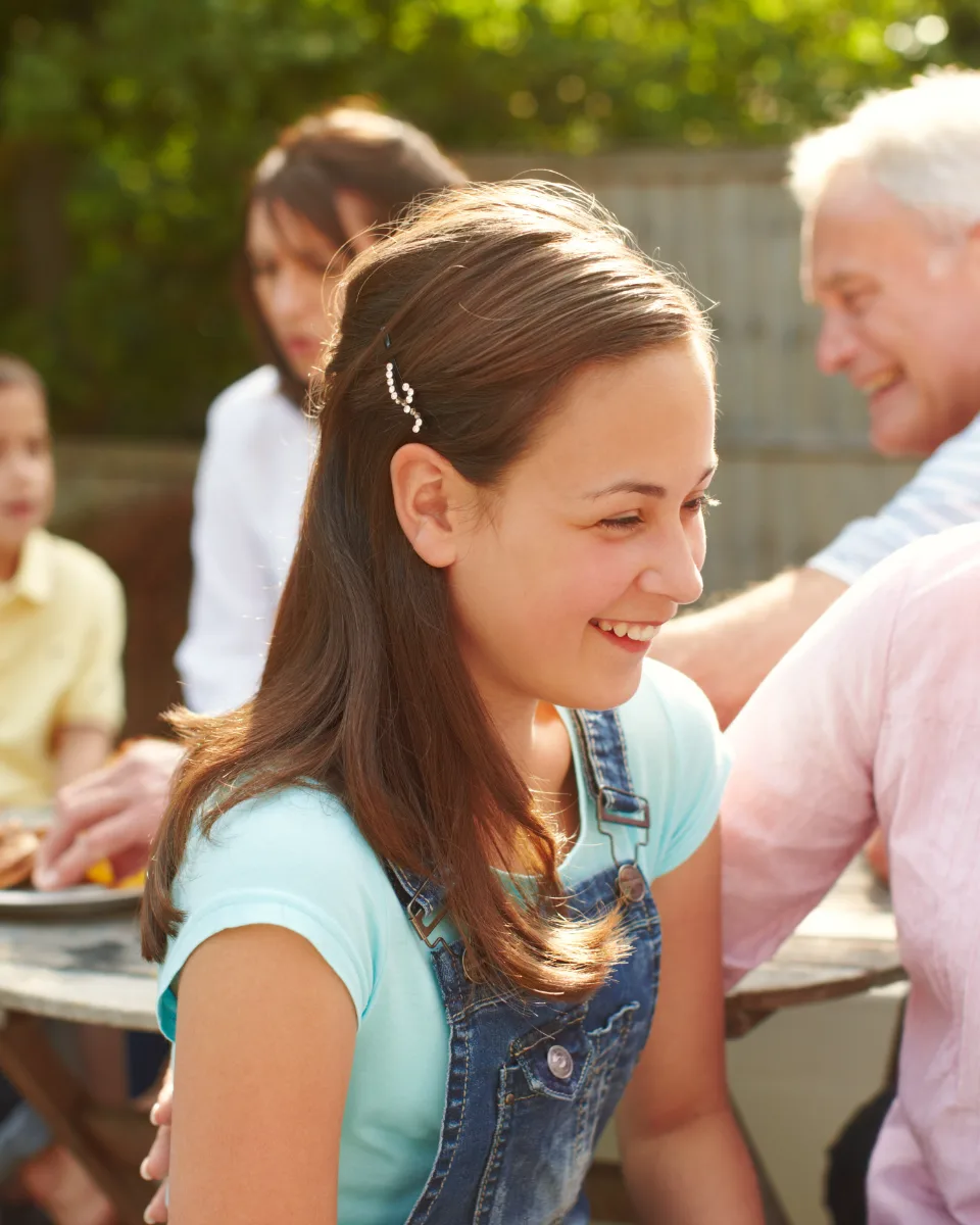 A multi-generational family gathered outdoors