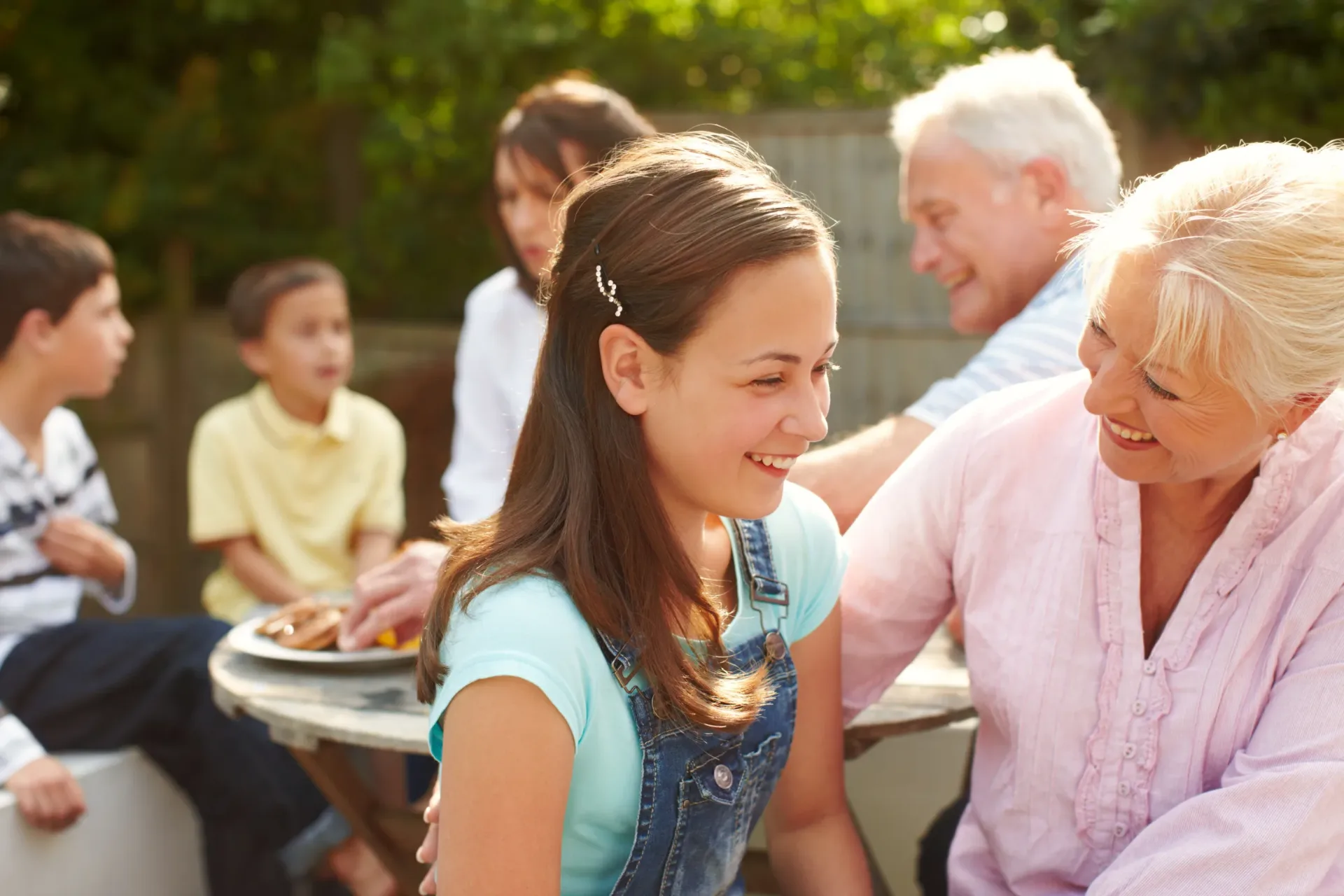A multi-generational family gathered outdoors