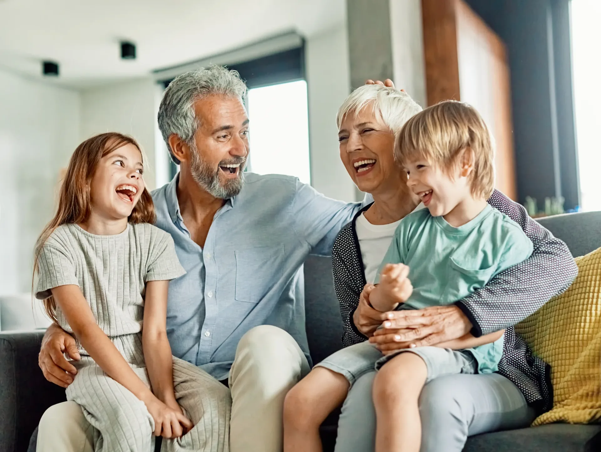 A family relaxing together on a sofa at home