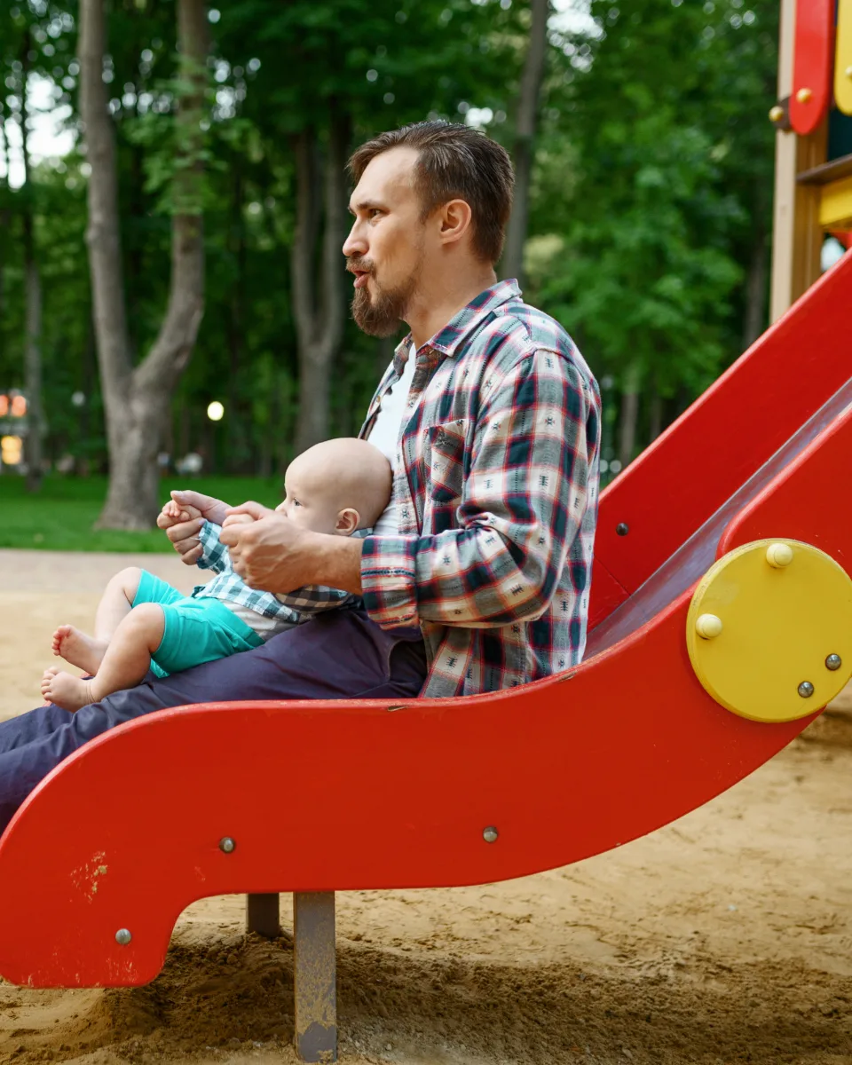 A father and his baby at a playground